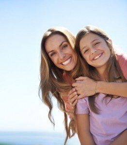 Mother and her daughter showing off their white teeth with huge smiles in Southhampton PA