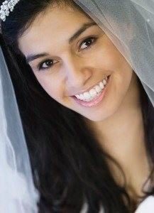 Patient after dental veneers in her wedding gown showing off how perfect her smiles looks for her special day.